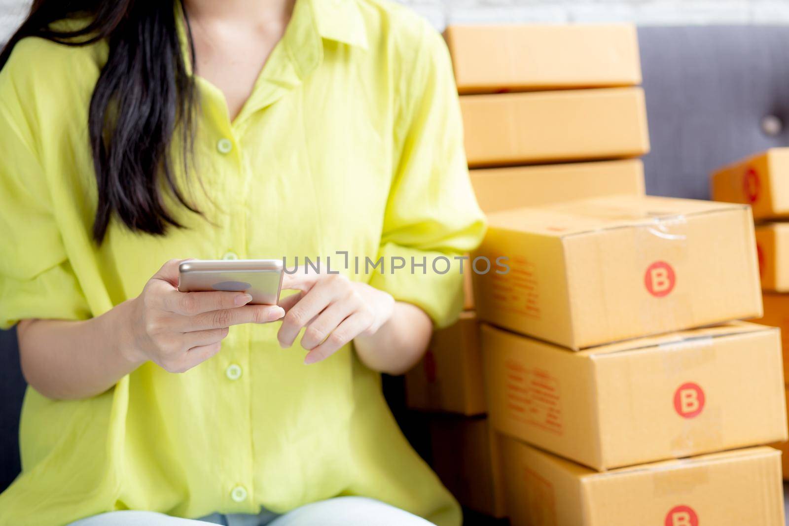 Closeup hand of young asian woman is entrepreneur check order from phone with customer while purchase online, logistic and delivery, online shopping, female is seller of business SME.