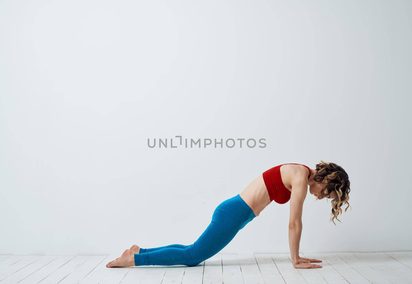 Woman doing gymnastics exercises yoga asana sportswear. High quality photo