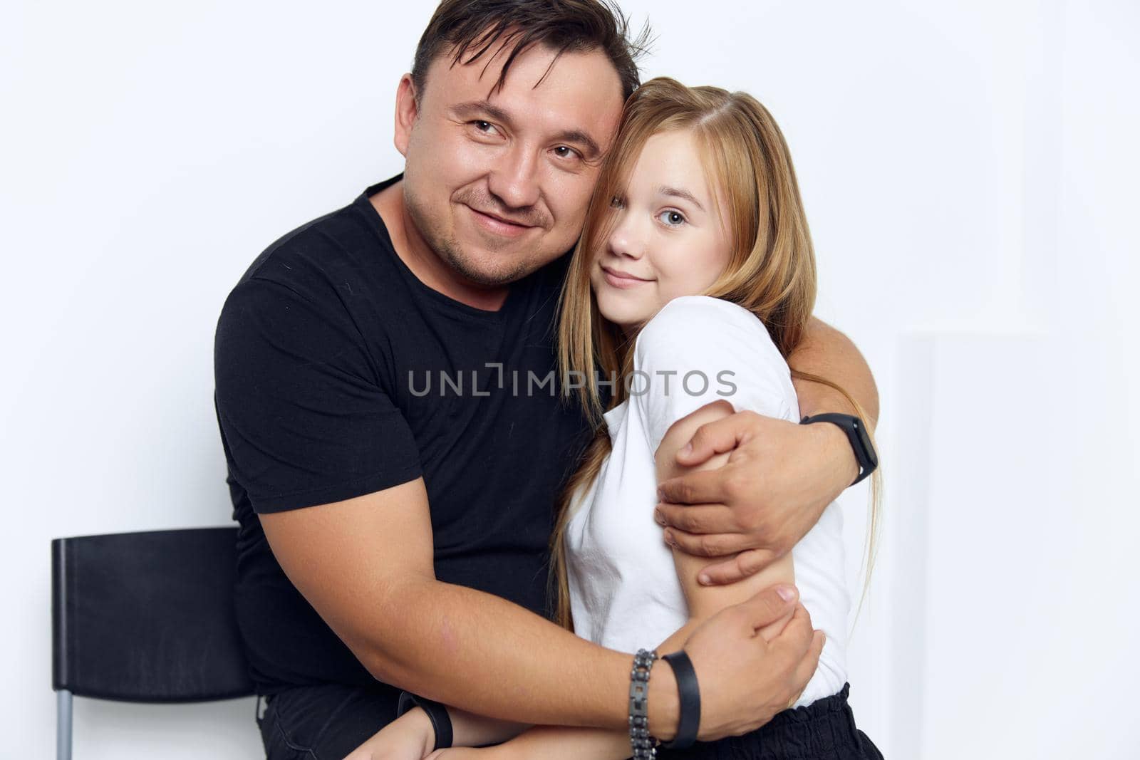 father hugs daughter family studio lifestyle close-up. High quality photo