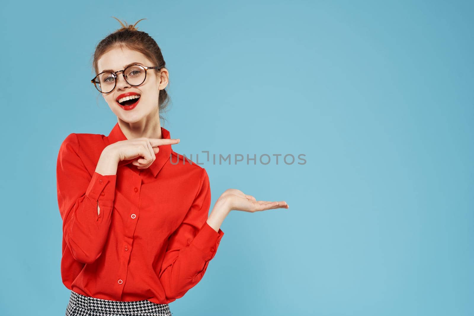 emotional business woman in red shirt wearing glasses blue background lifestyle. High quality photo