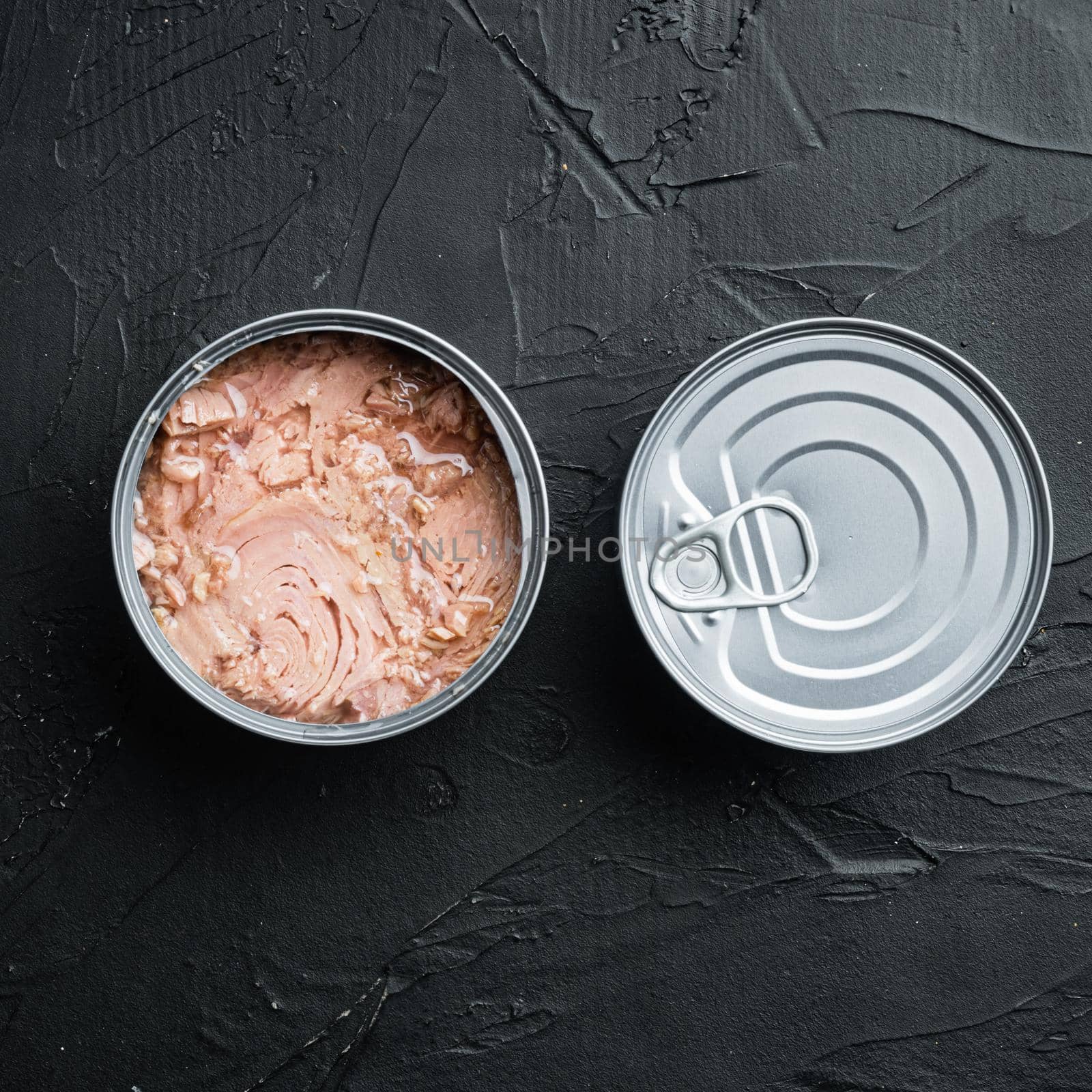 Canned Albacore Wild Tuna set, in tin can, on black background, top view flat lay, with copyspace and space for text, square format