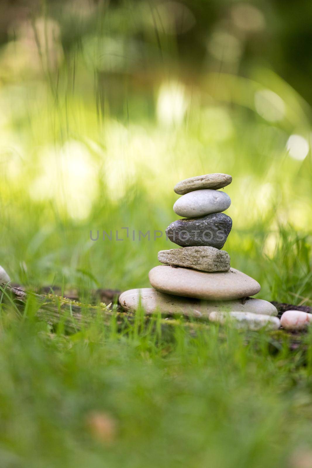 Spirituality: Stone cairn in the park. Balance and relaxation. by Daxenbichler