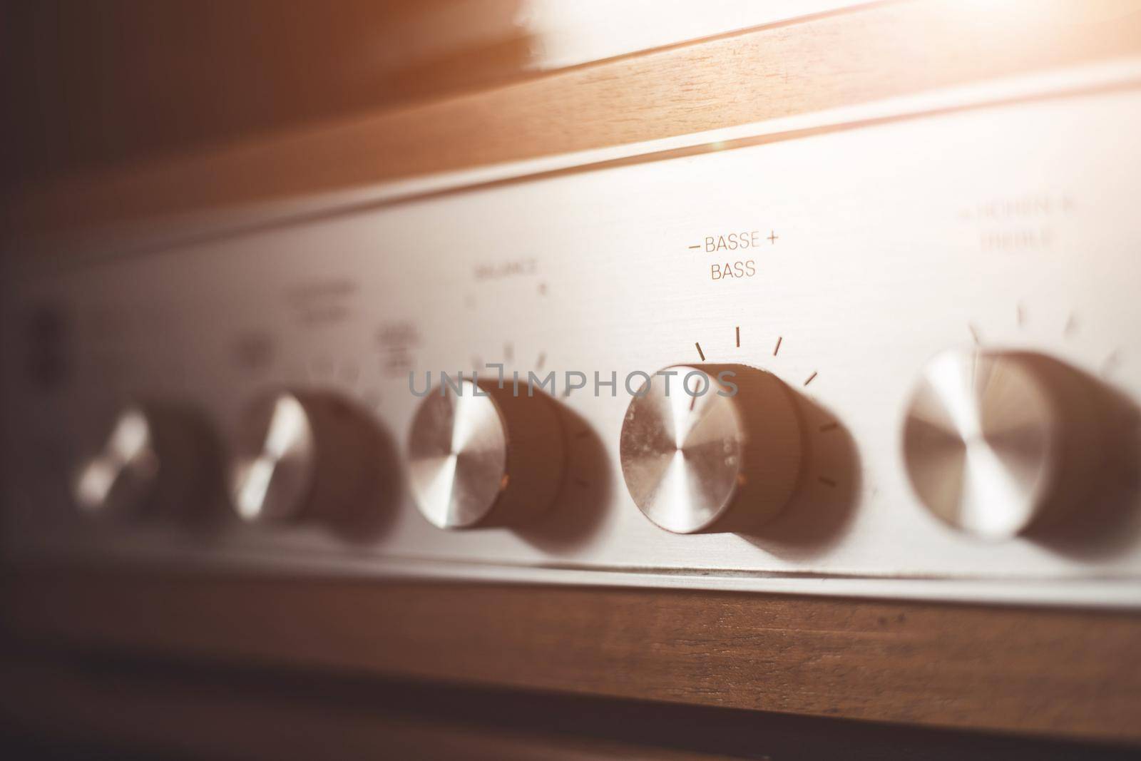Control knops of silver wooden vintage amplifier, closeup