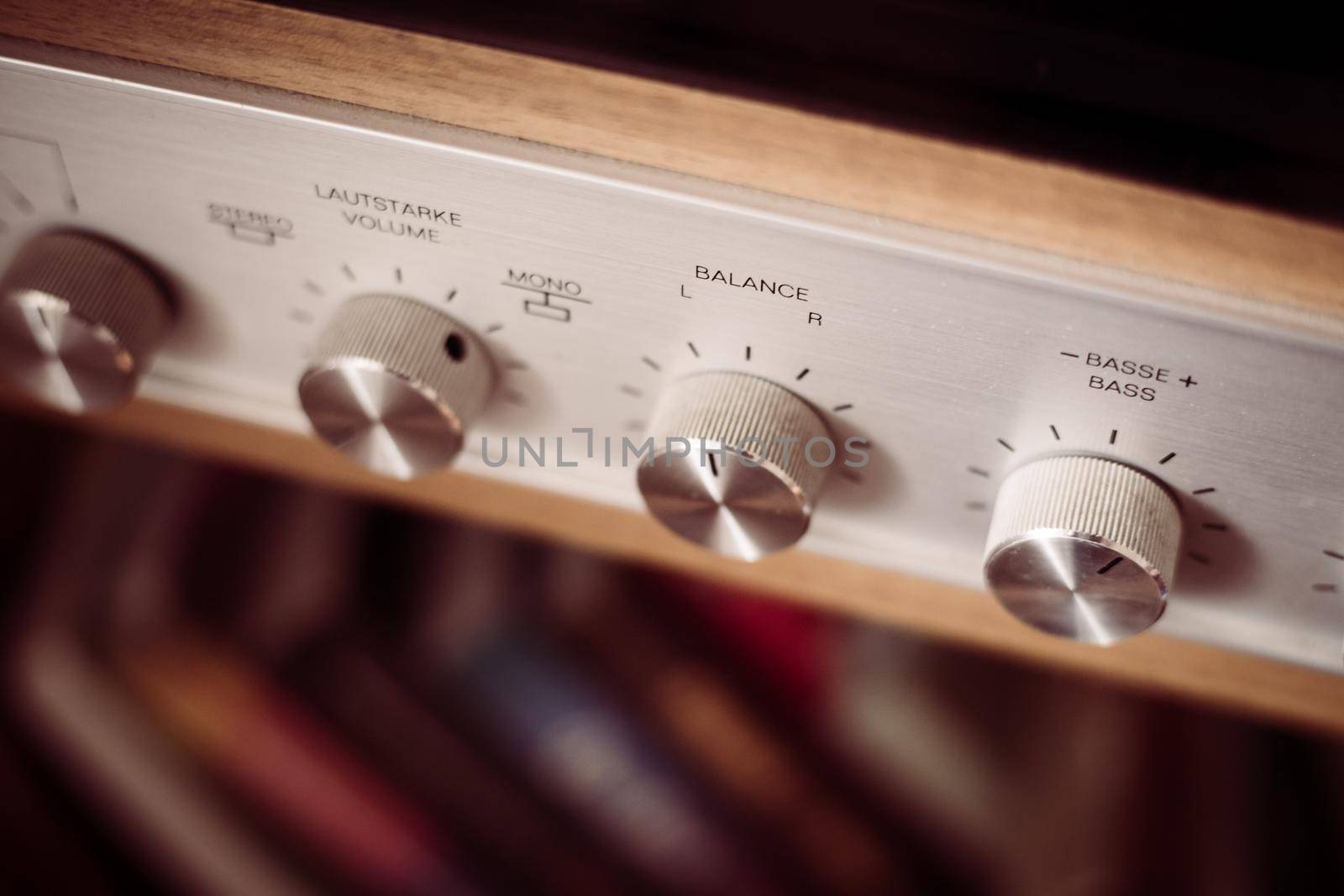 Control knops of silver wooden vintage amplifier, closeup