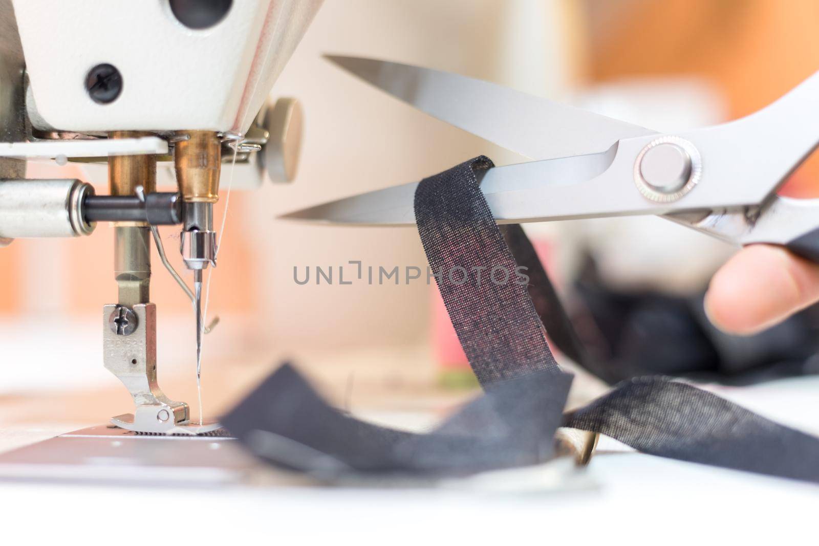 Close up of sewing metal sewing scissors with sewing thread, tailor workshop