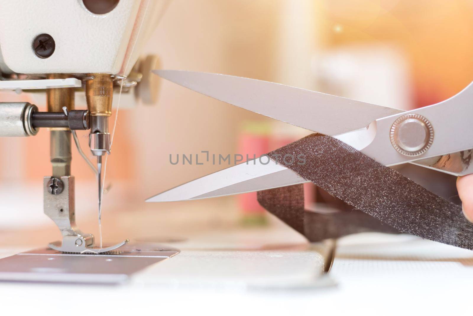 Close up of sewing metal sewing scissors with sewing thread, tailor workshop