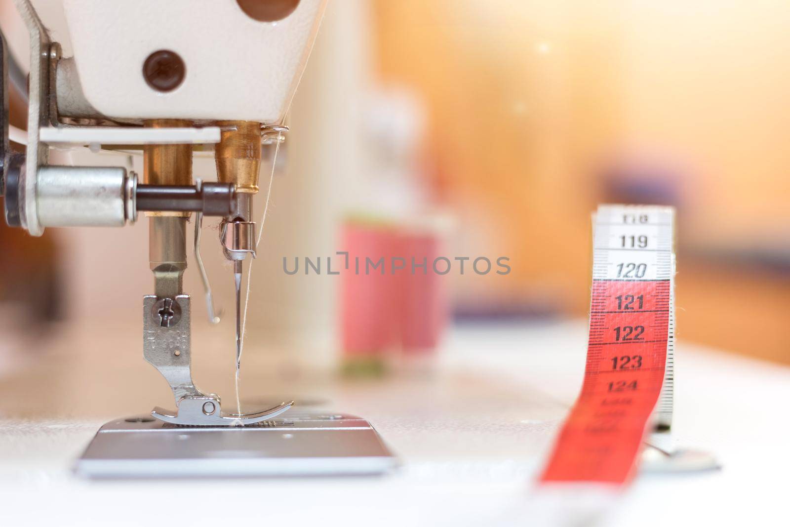 Close up of sewing metal sewing needle with sewing thread, tailor workshop