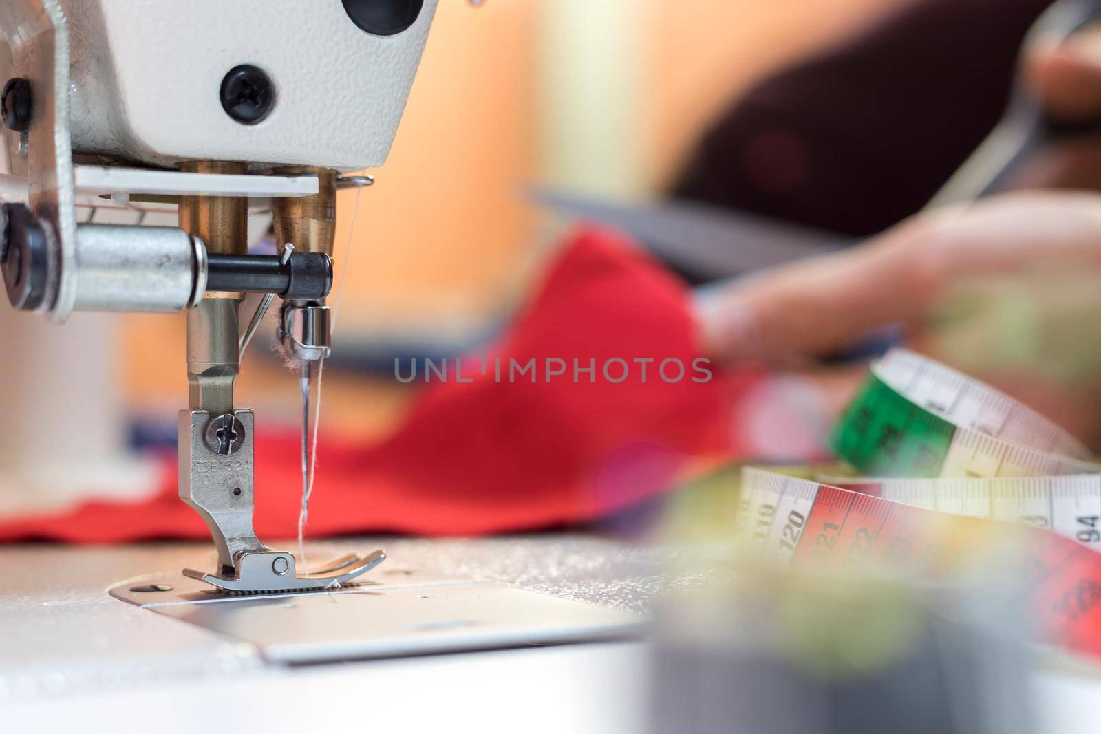 Close up of sewing metal sewing needle with sewing thread, tailor workshop