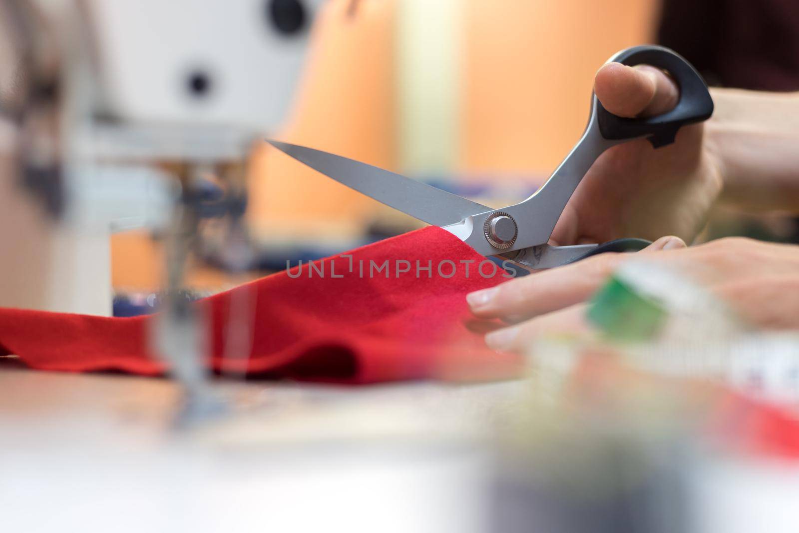 Close up of sewing metal sewing needle with sewing thread, tailor workshop