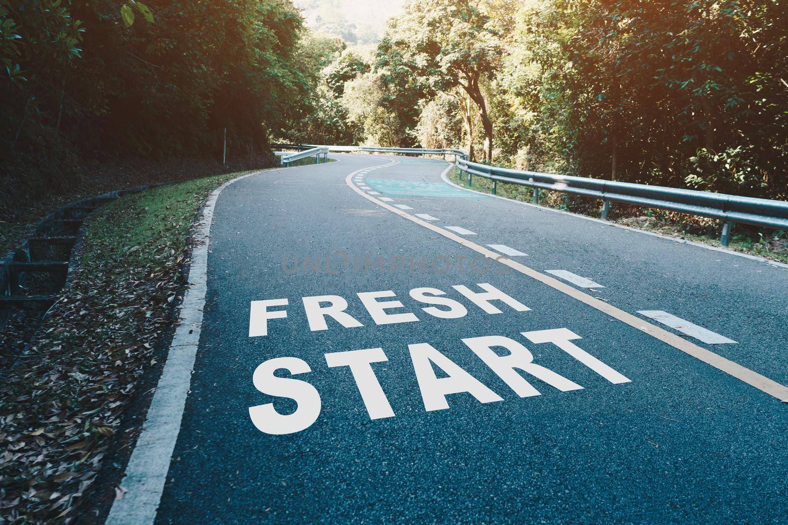 Fresh start on road lane in wood  represents the beginning of a journey to the destination in business planning, strategy and challenge or career path, opportunity. by Suwant