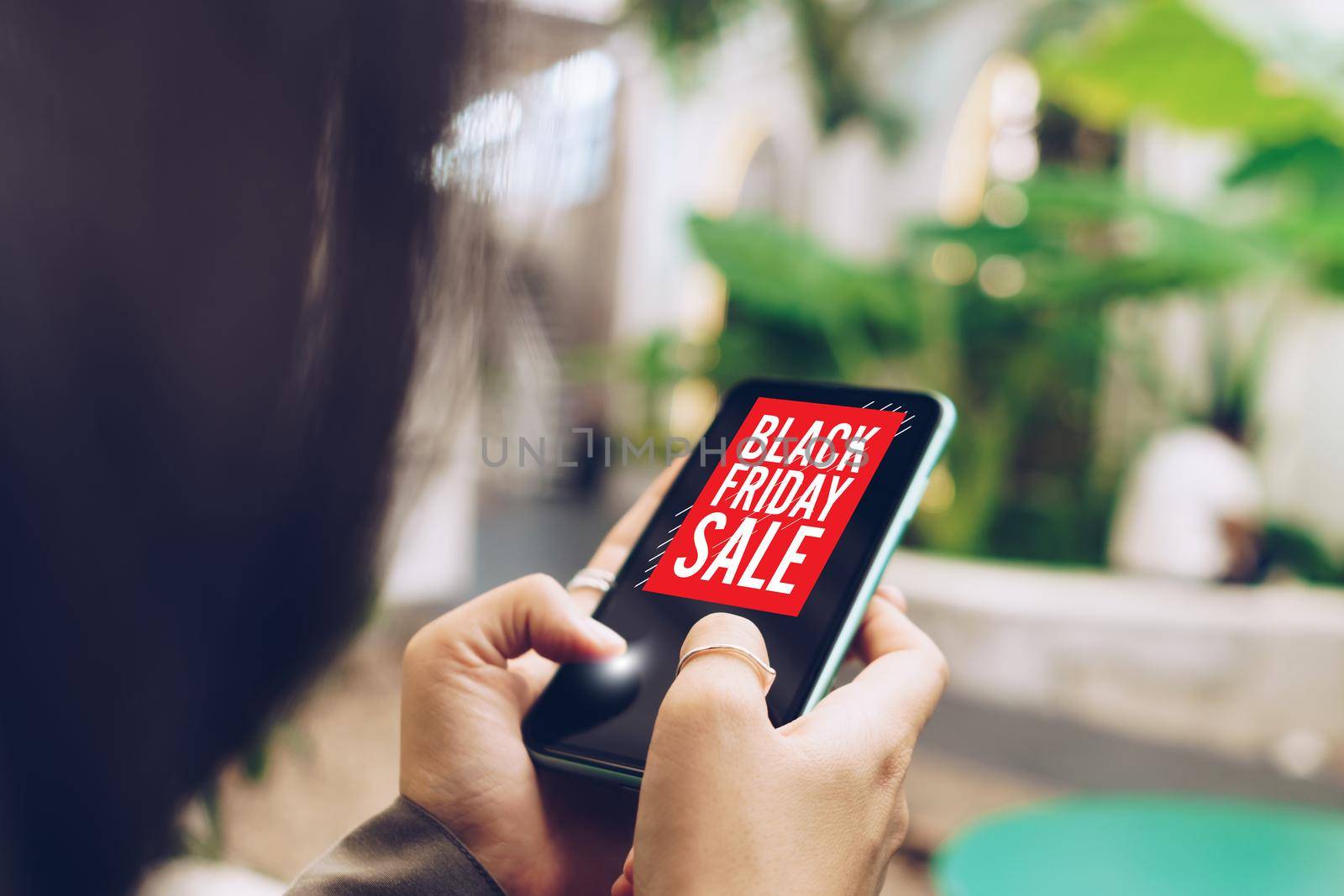 Women hand using smartphone do online selling on black friday sale for people shopping online with chat box, cart, dollar icons pop up. Social media maketing. by Suwant