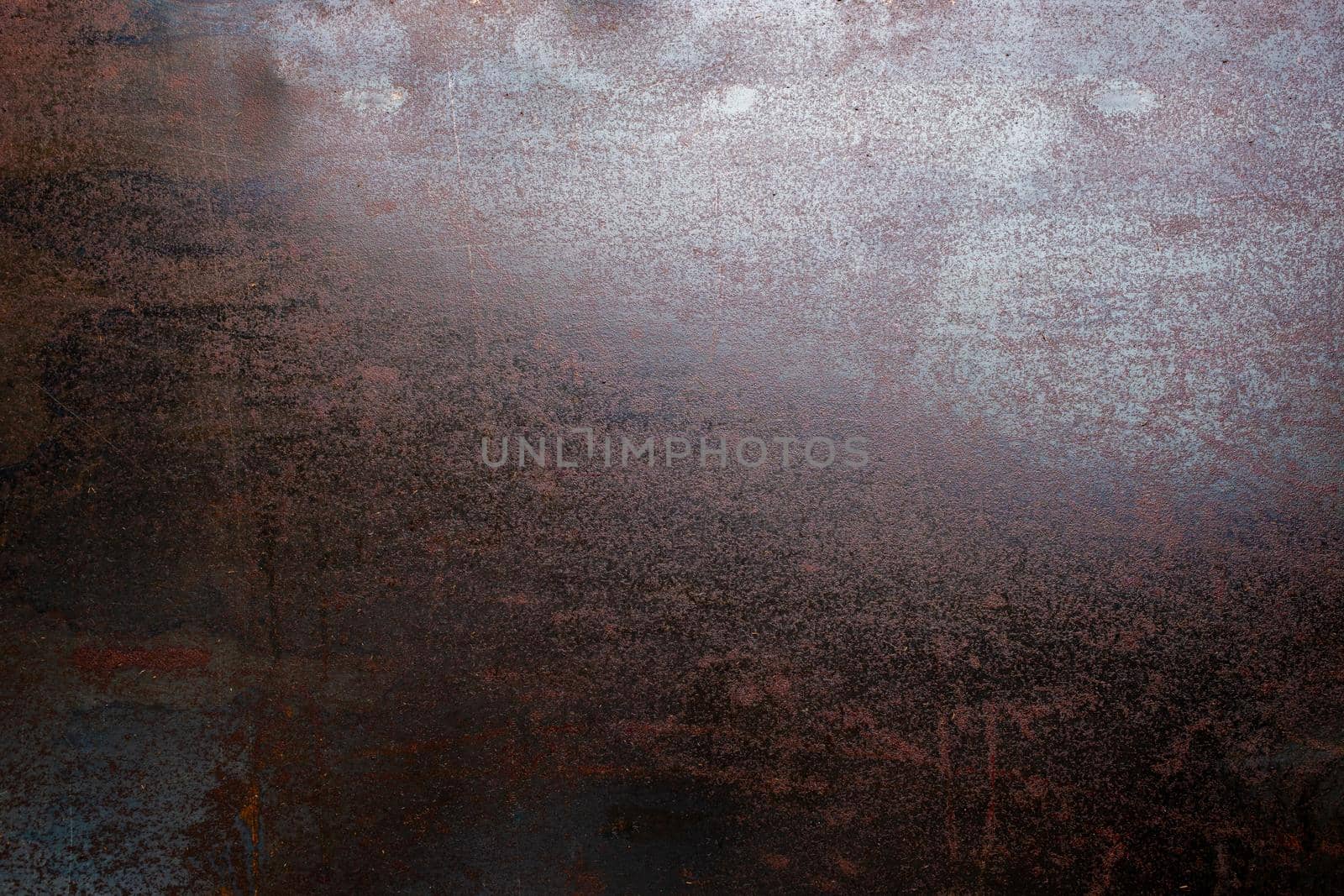 rusted black steel sheet surface covered with machine oil in flat lay perspective