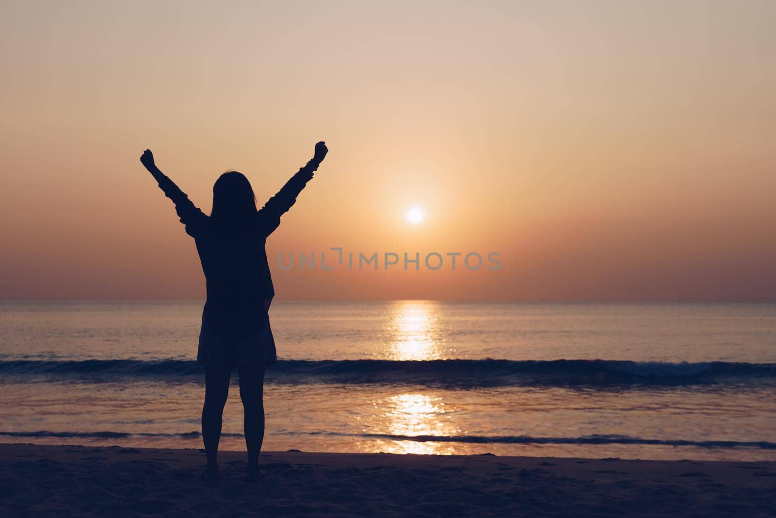 Woman travel around the world with summer sunset beach freedom and relax life concept.