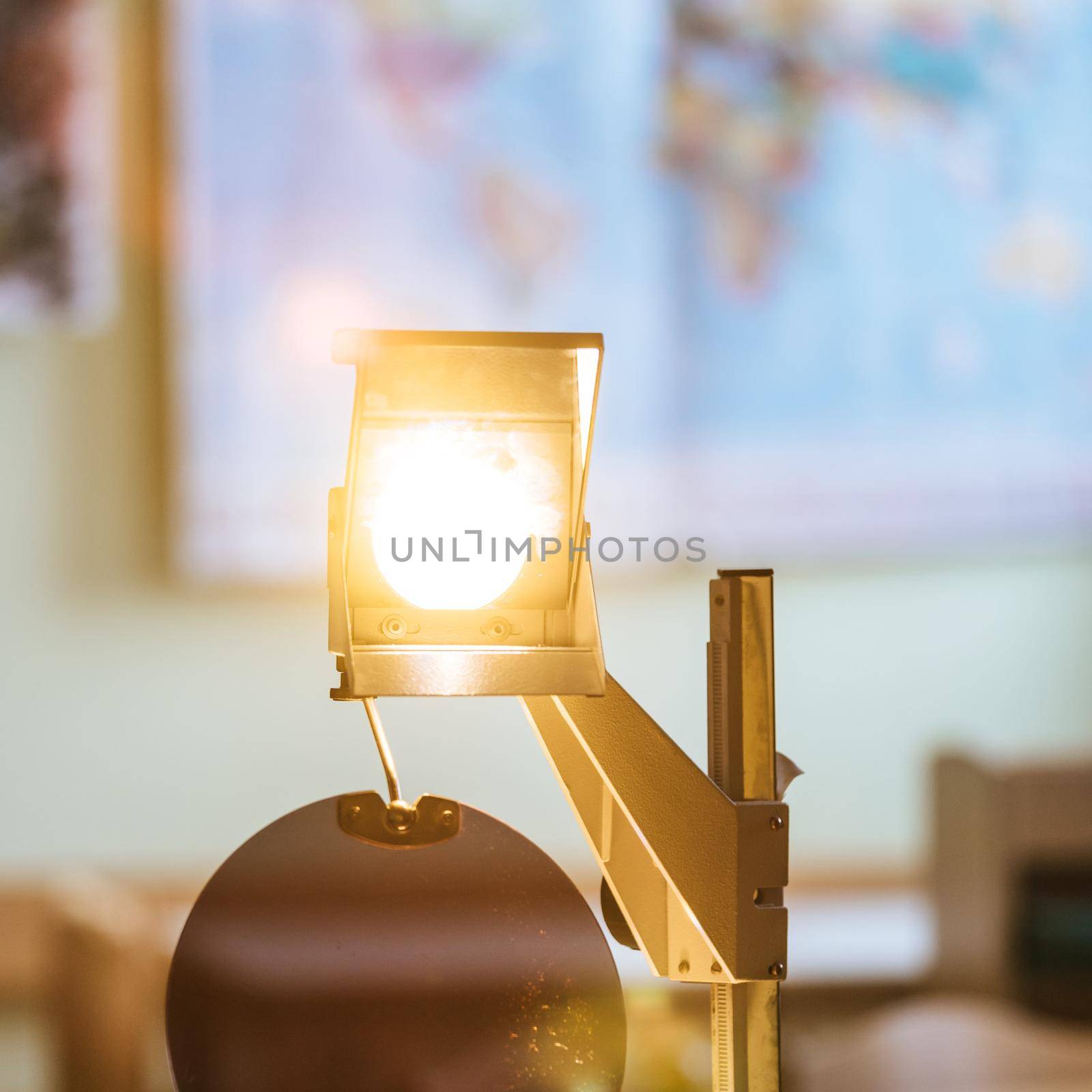 Schooling concept: Retro overhead projector in classroom, educational system by Daxenbichler