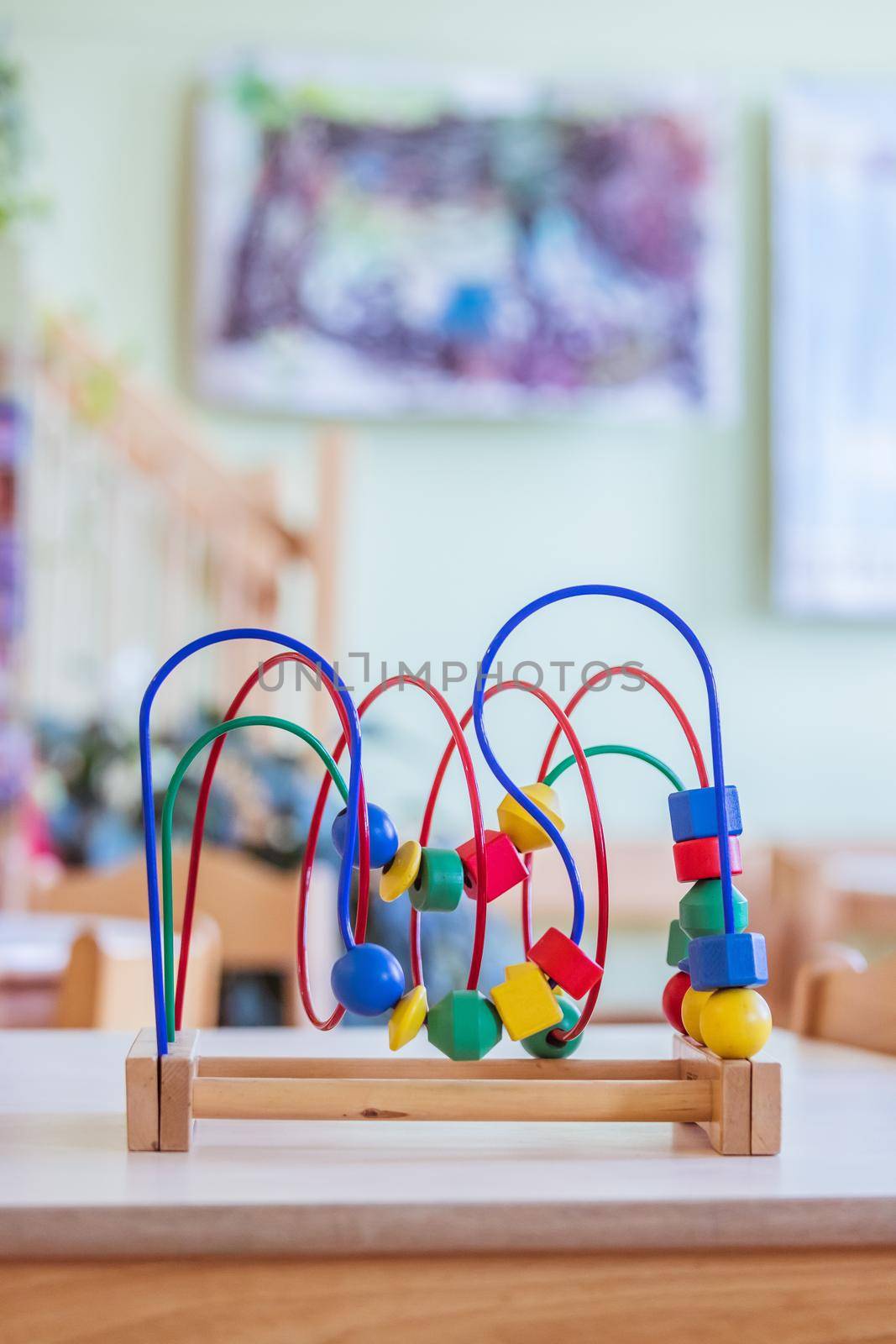 Childhood and socialization concept: Colorful wooden toy in the kindergarten by Daxenbichler