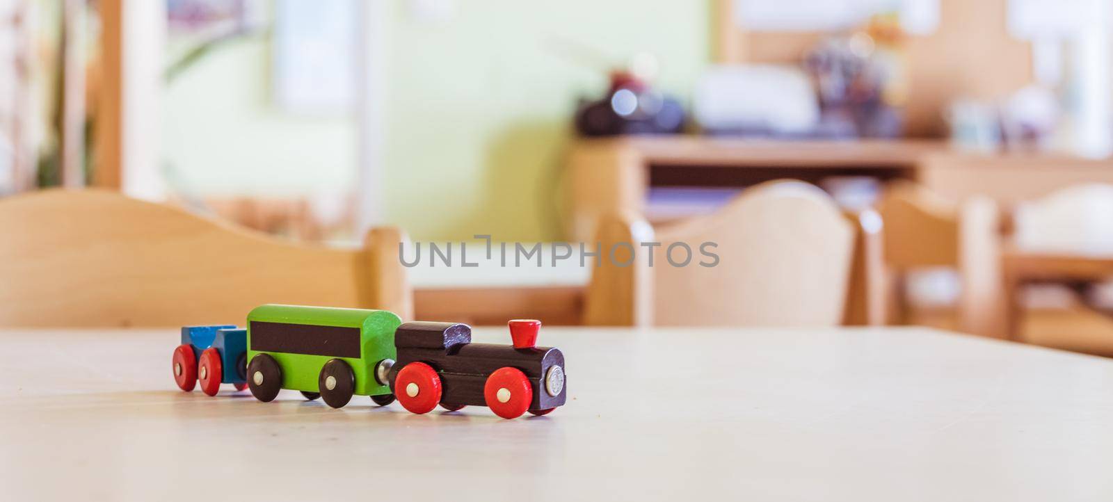 Children development concept: Close up of wooden toy railroad in the kindergarten by Daxenbichler