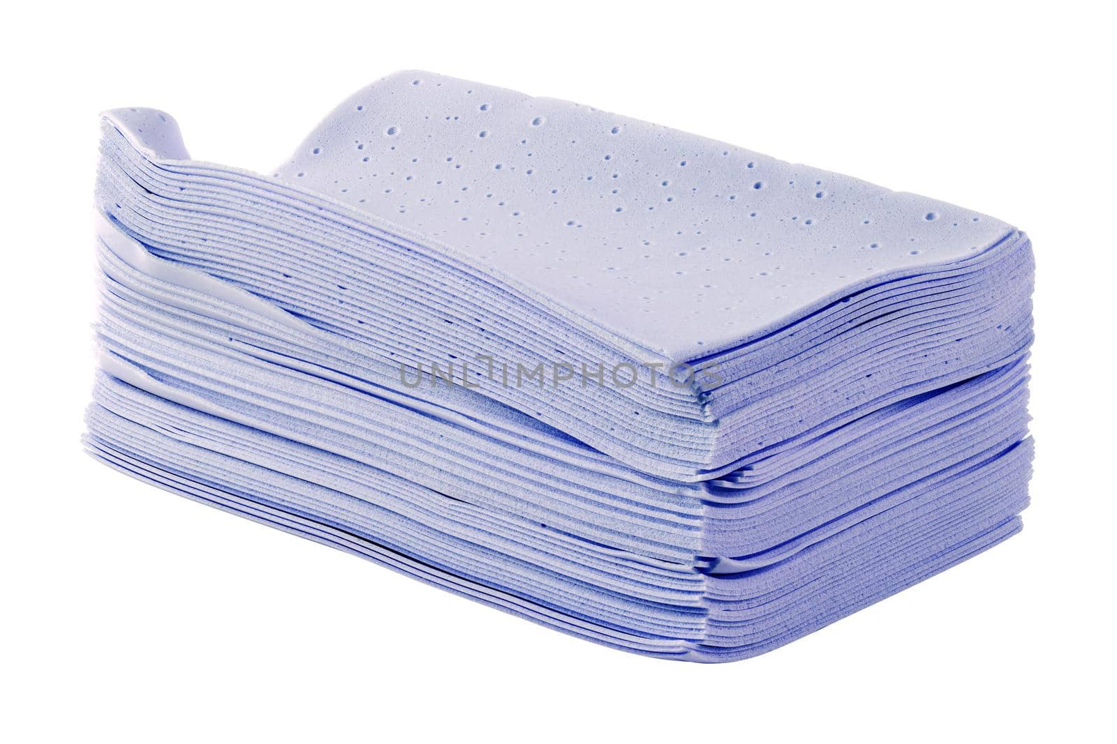 stack of purple liquidless and powderless laundry detergent squares sheets isolated on white background.