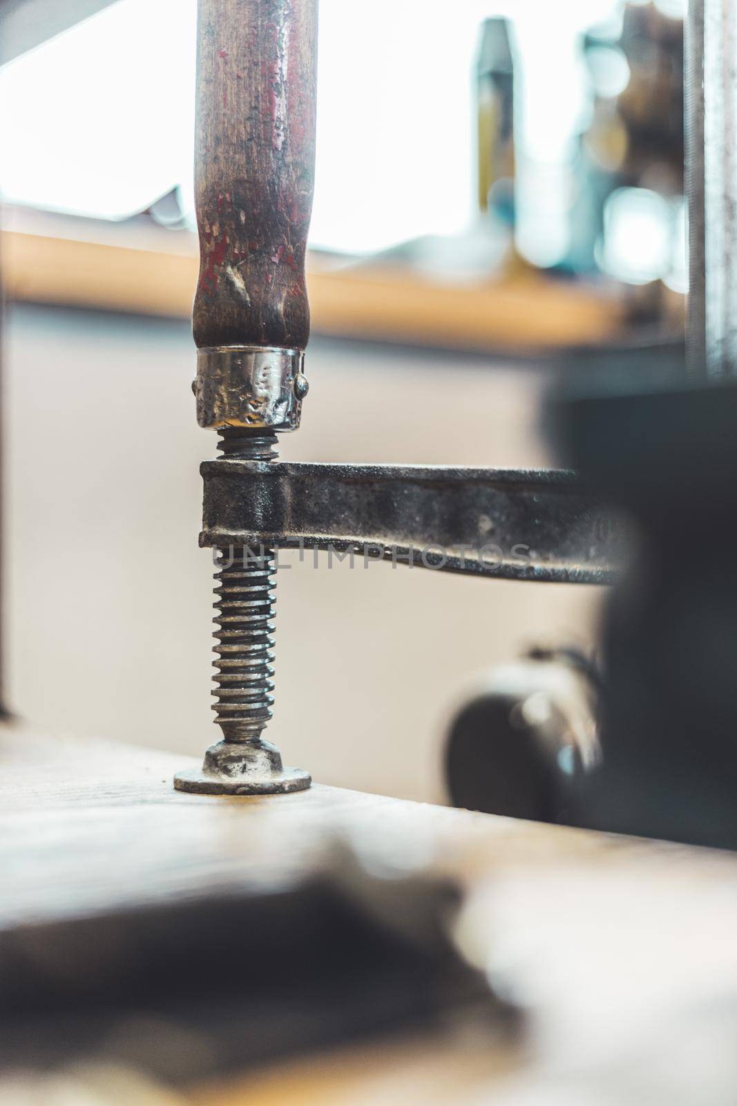 Close up of a metal screw clamp in a garage workshop