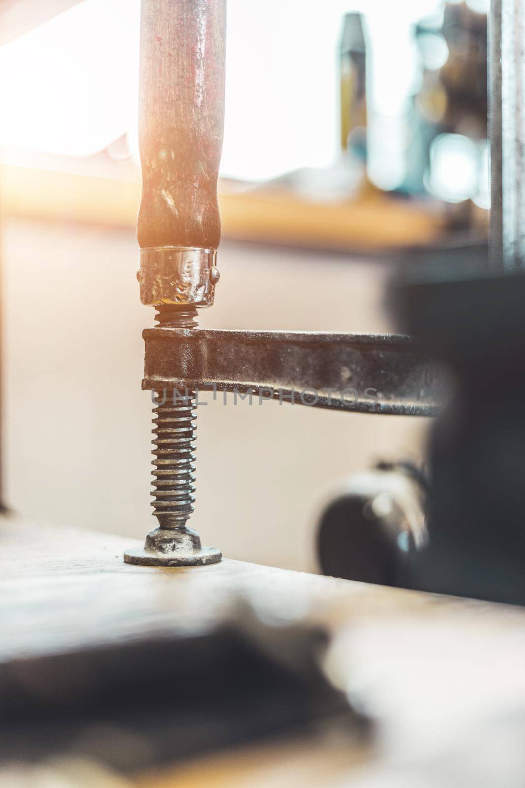 Close up of a metal screw clamp in a garage workshop