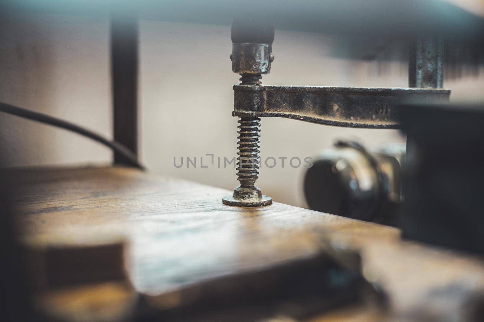 Close up of a metal screw clamp in a garage workshop