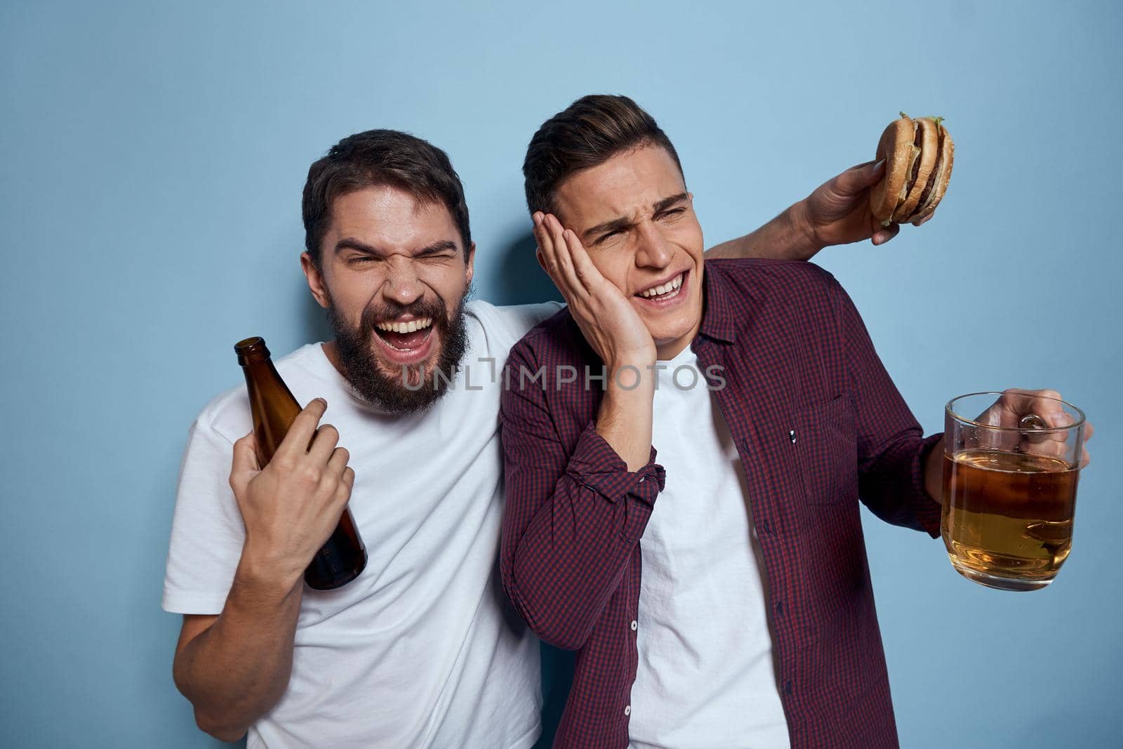 two friends with beer fun entertainment lifestyle blue background by SHOTPRIME