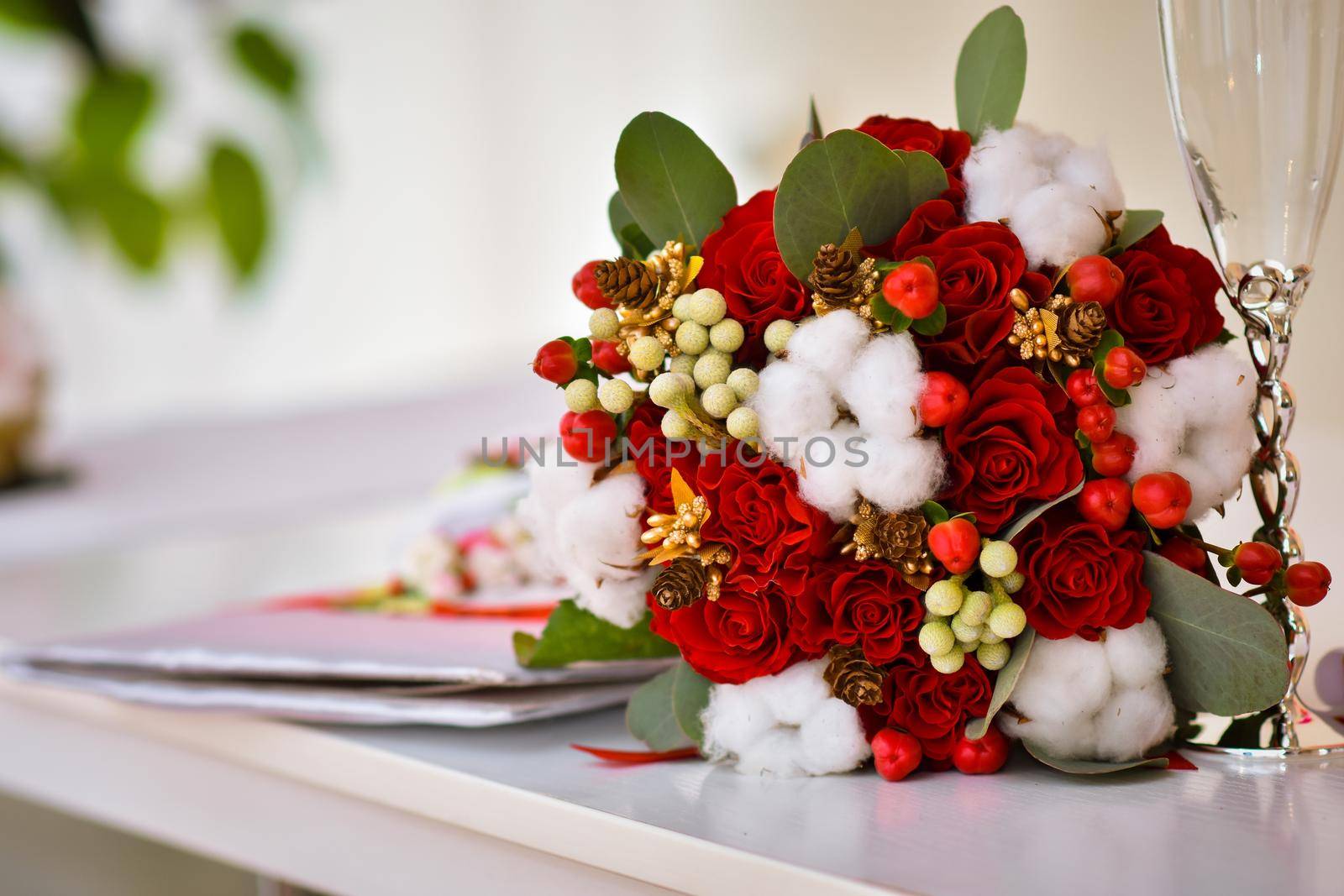 wedding flowers on the table. A marriage certificate and a glass. Registration of marriage in the registry office.