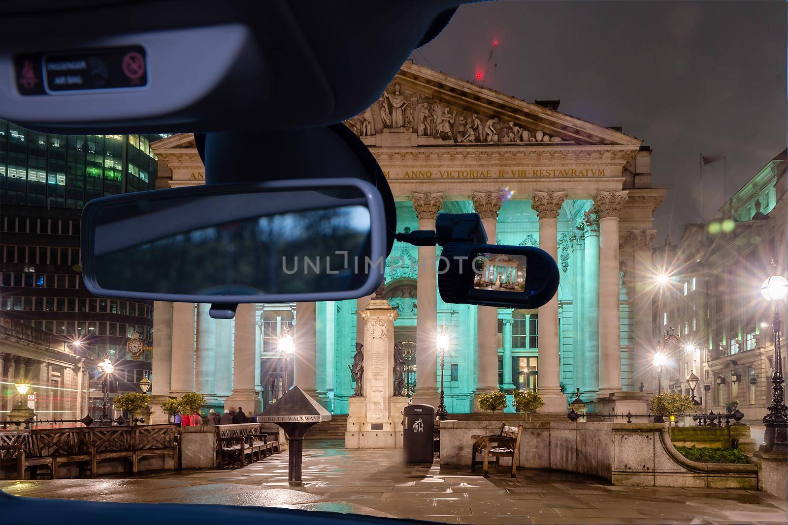 Looking through a dashcam car camera installed on a windshield with view of the Royal Exchange Building in the financial district of London, UK