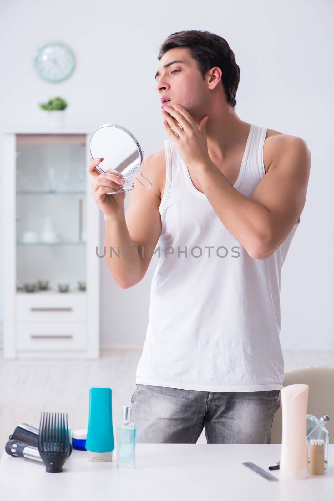 Young handsome man staring in the mirror 