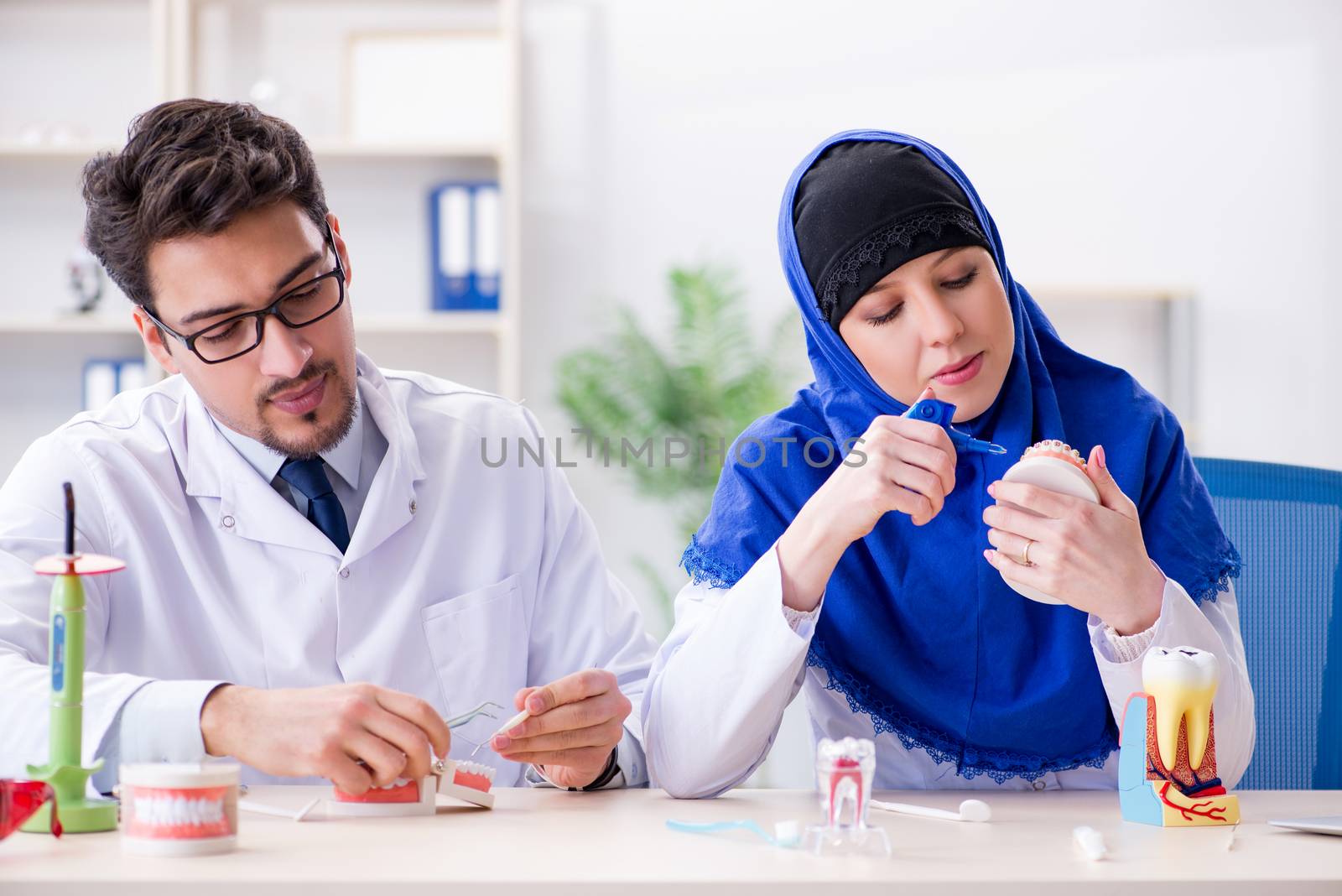 Dentist doctor and assistant working on new tooth implant