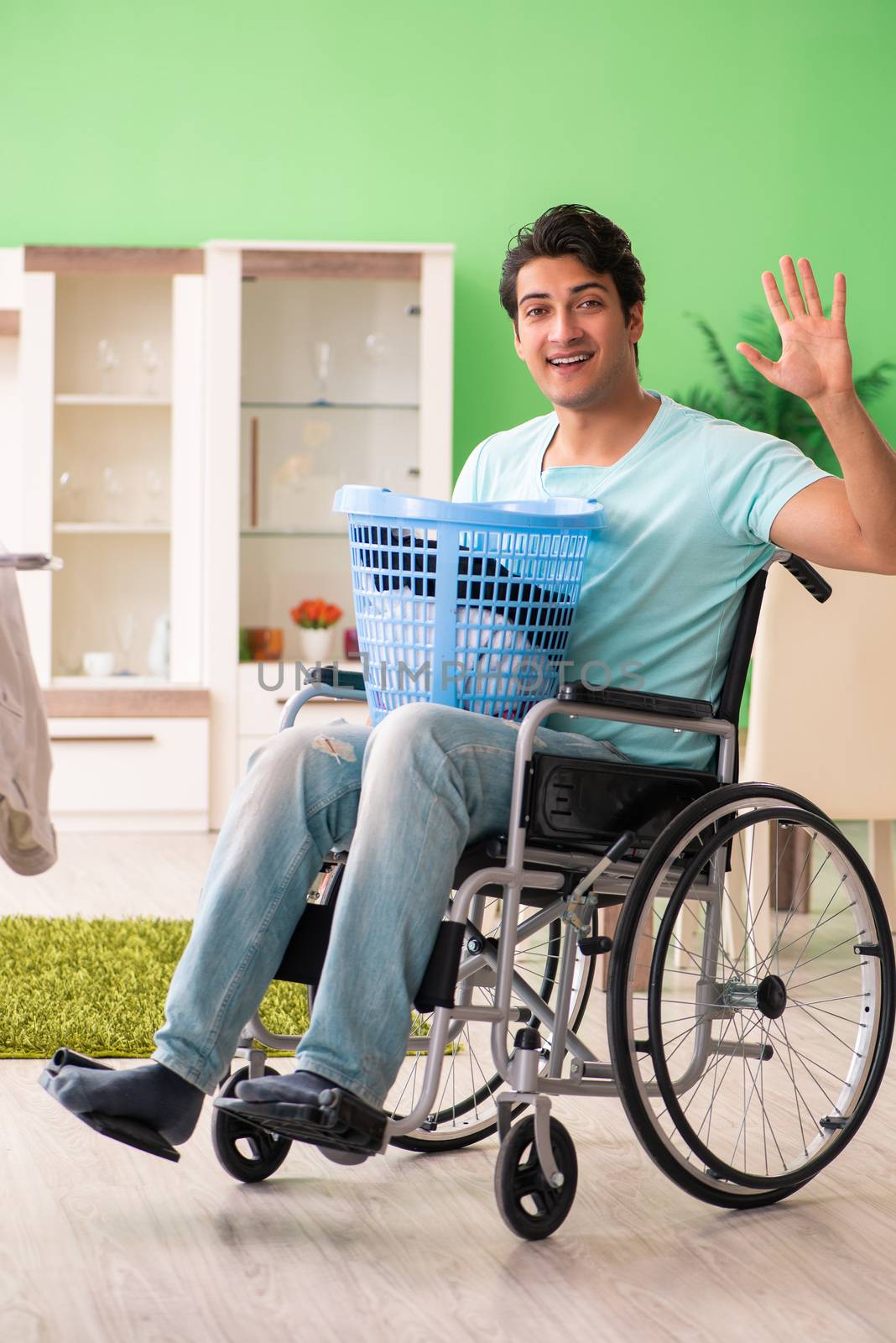 Disabled man on wheelchair doing laundry