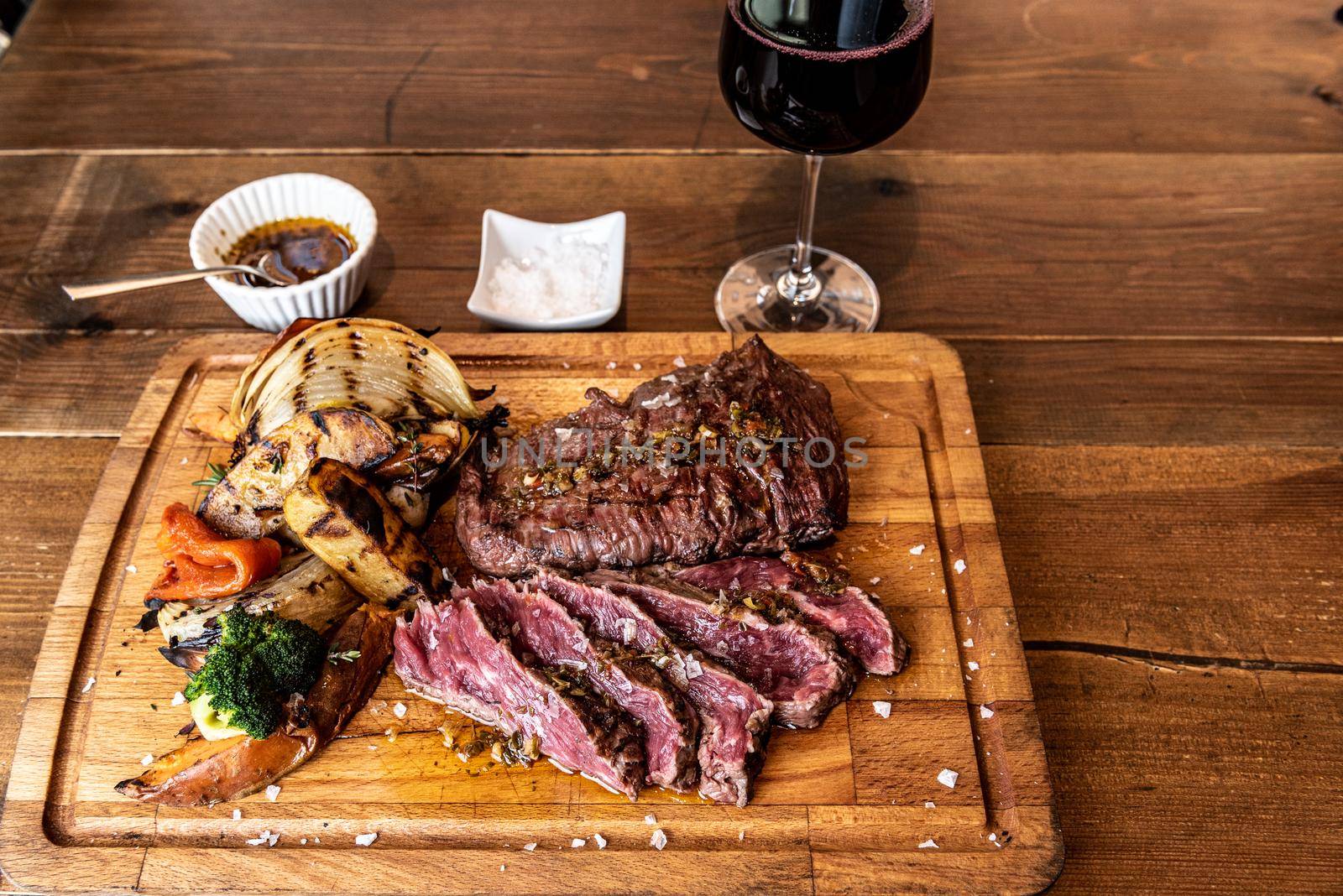 Argentine cut of meat called Vacio with chorizos and chimichurri.