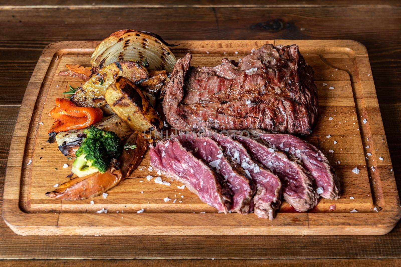 Argentine cut of meat called Vacio with chorizos and chimichurri.