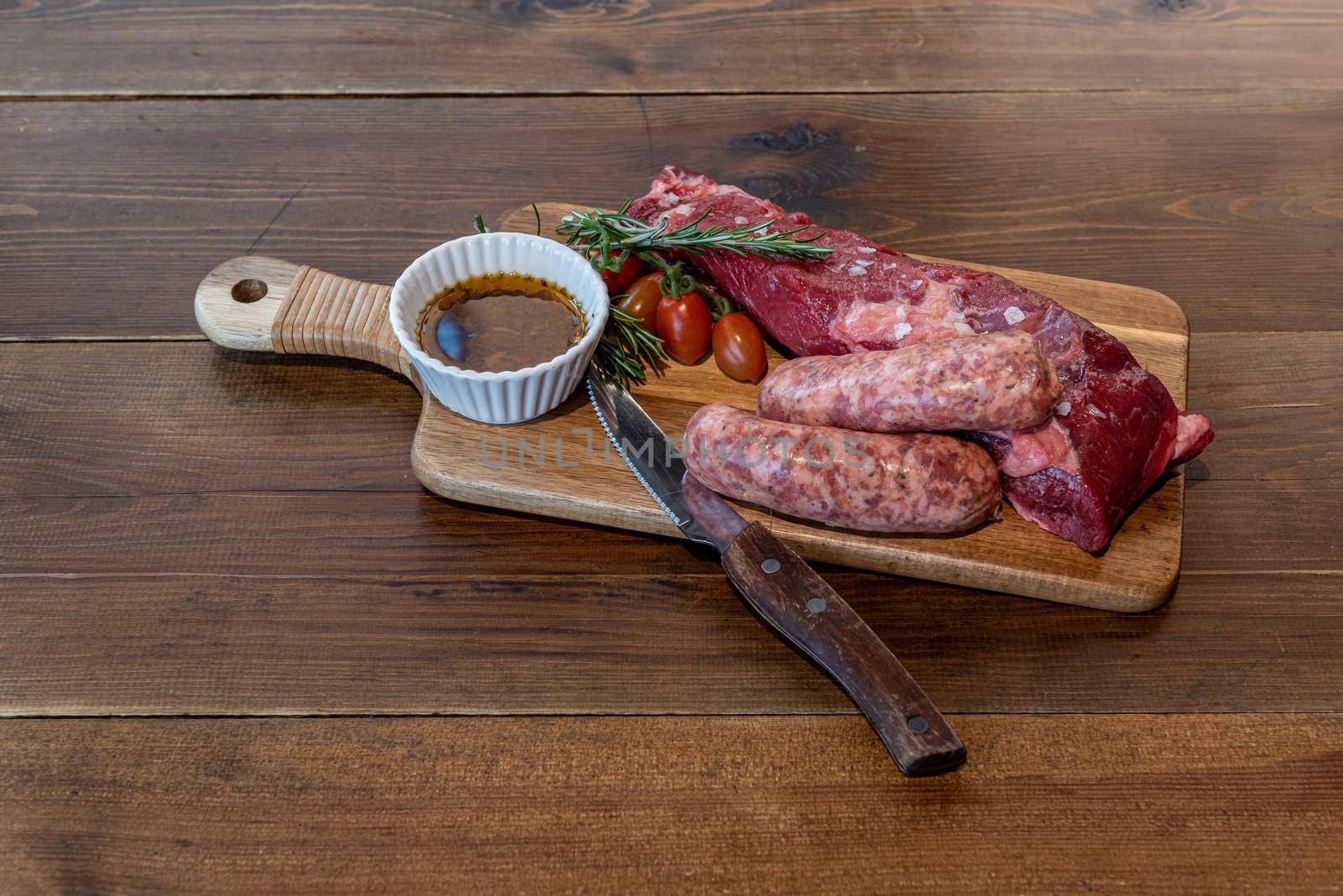 Argentine cut of meat called Vacio with chorizos and chimichurri.