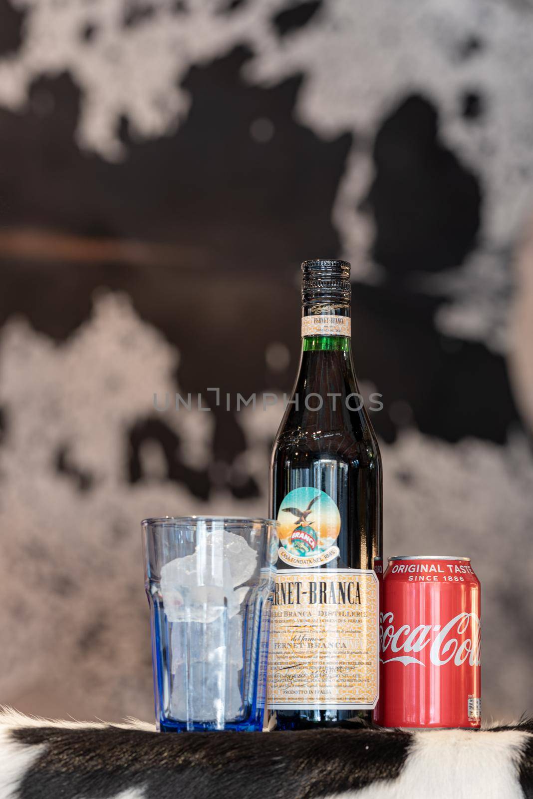 Andorra La Vella, Andorra: 2021 February 25: Typical Argentine drink, Fernet Braca with Coca Cola on cowhide in winter 2021.