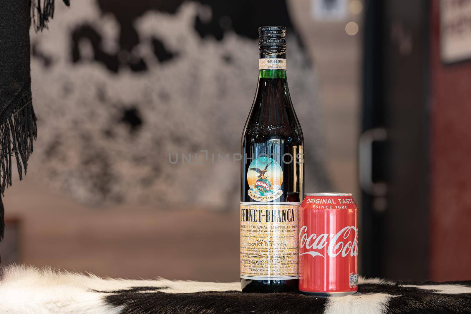 Andorra La Vella, Andorra: 2021 February 25: Typical Argentine drink, Fernet Braca with Coca Cola on cowhide in winter 2021.
