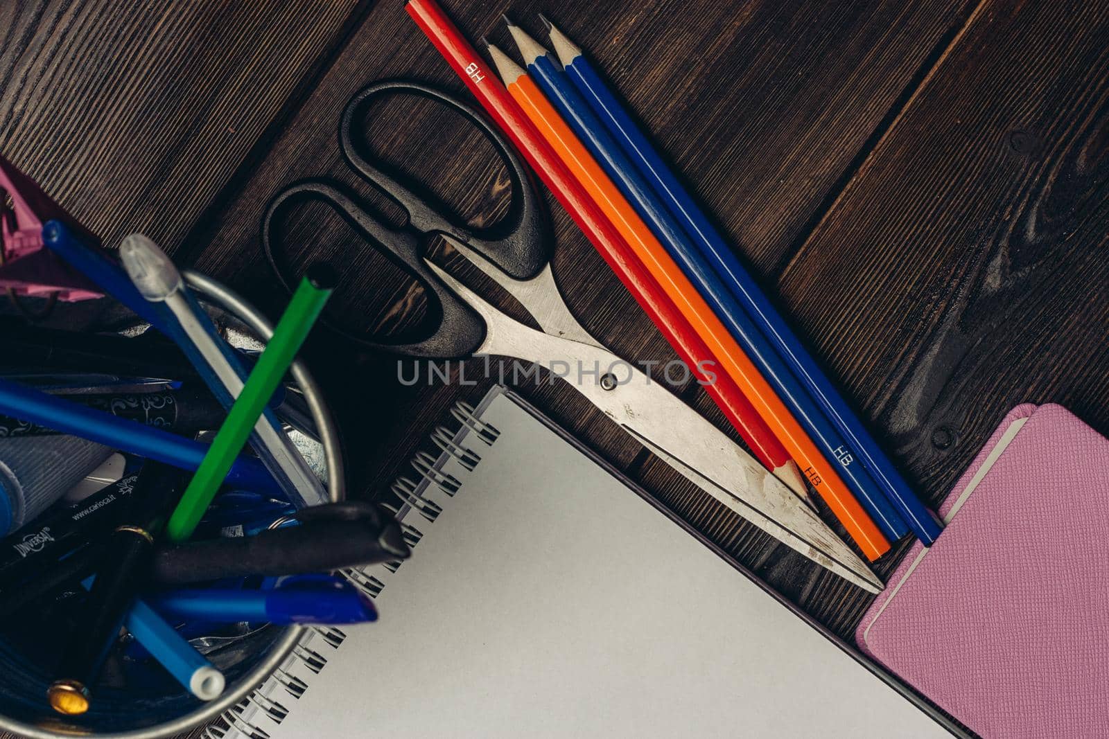 notepads colored pencils scissors office top view. High quality photo