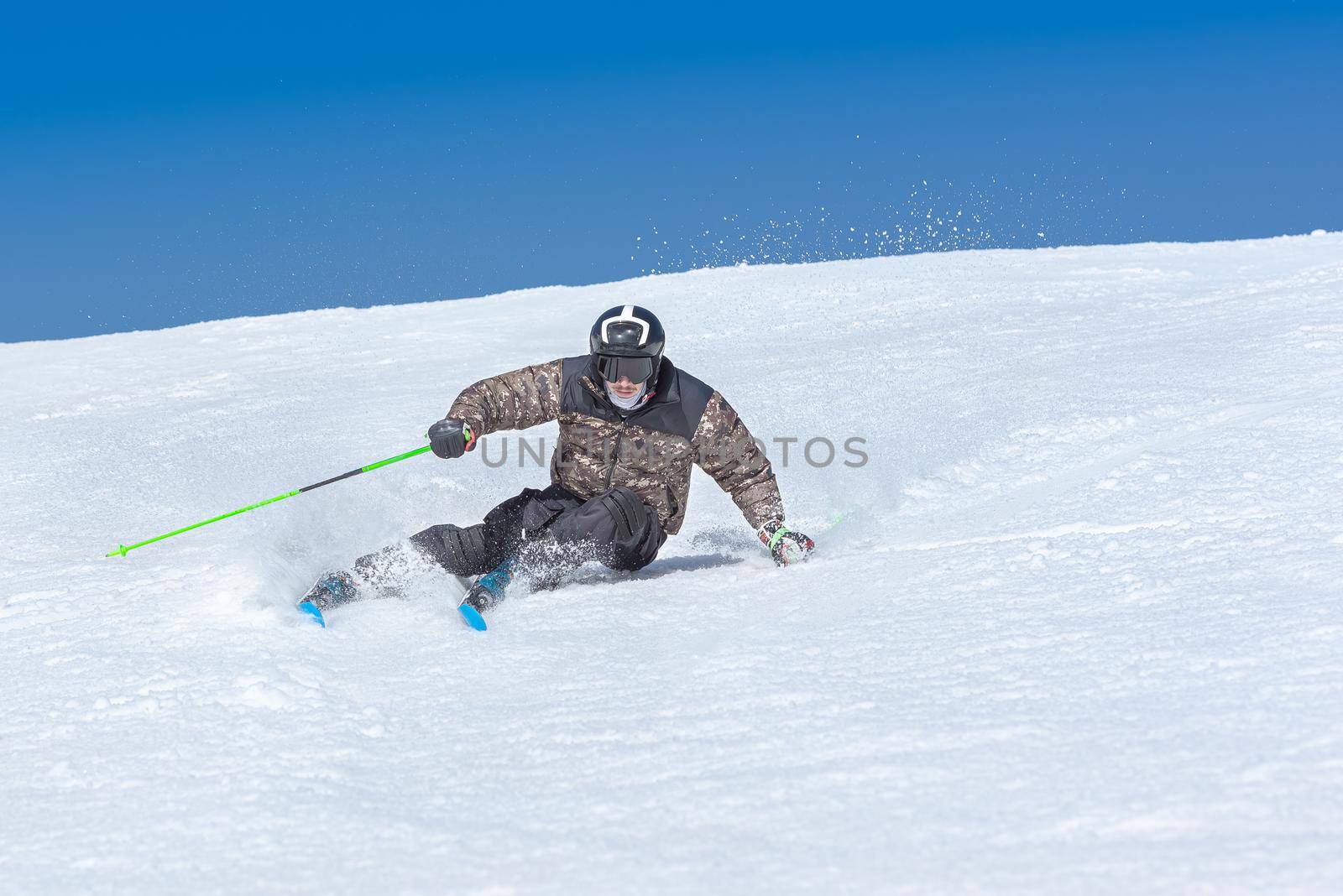 Young  man skiing on a sunny day in Andorra.