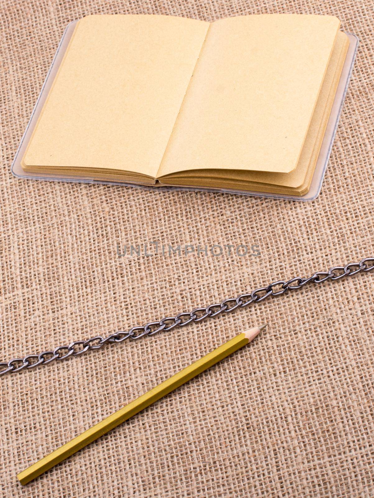 Pencil and notebook with a chain in the middle  by berkay