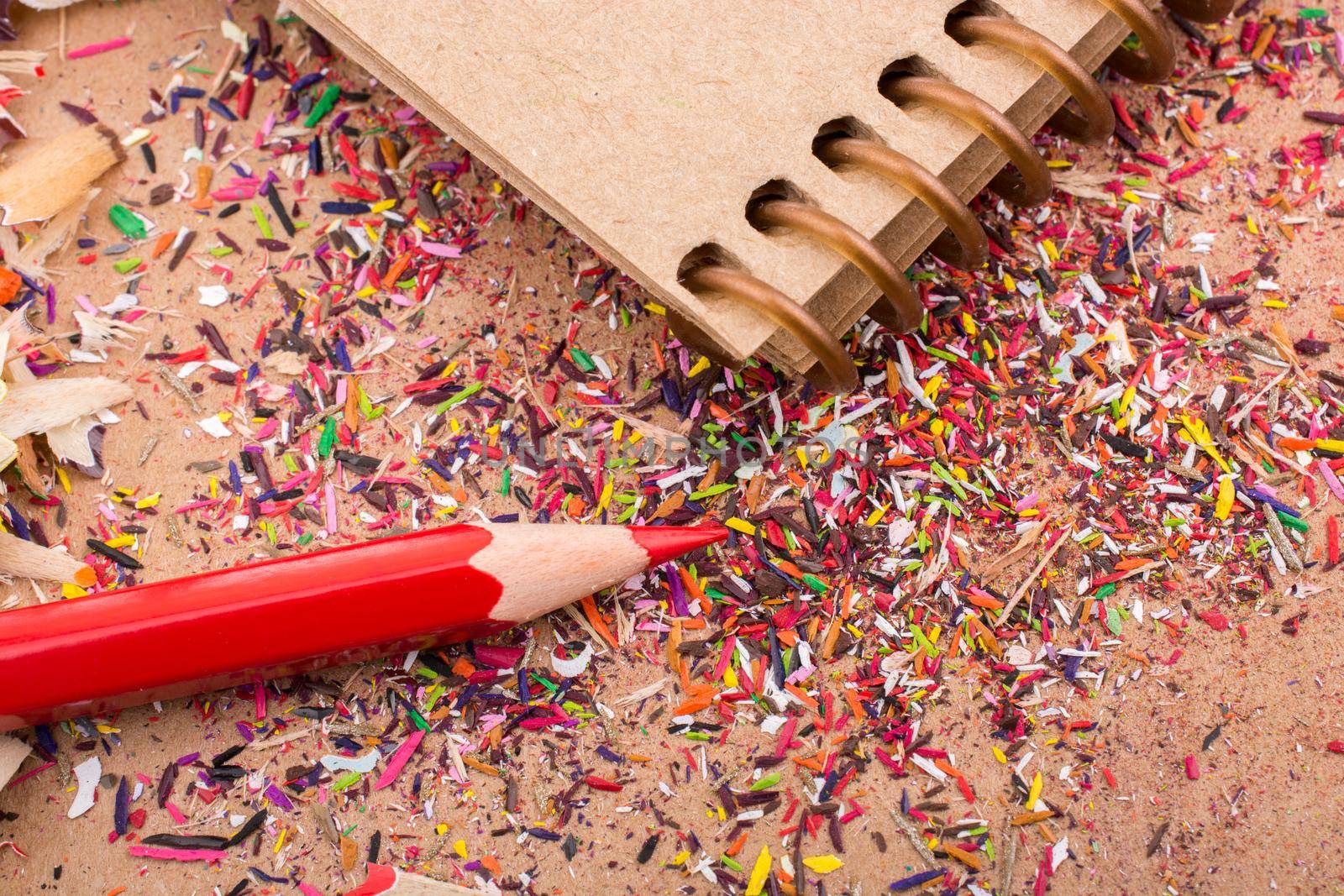 Red Color Pencil over some  pencil shavings