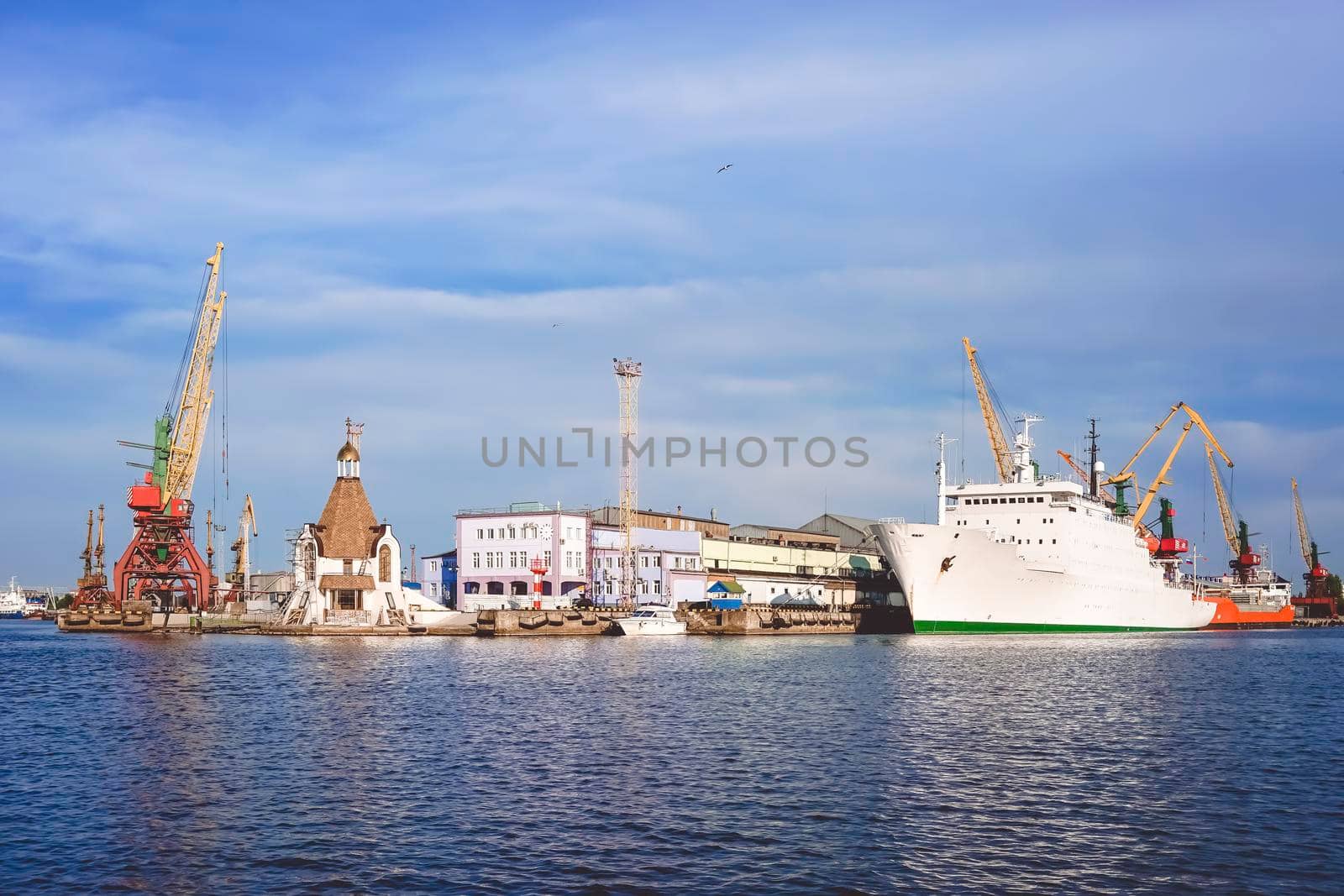 Kaliningrad , Russia. Port of a large Russian city with ships and various equipment on the background of the river.