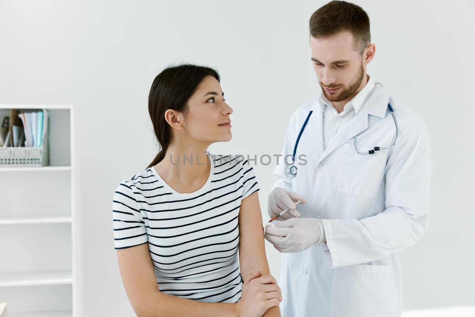 male doctor giving an injection to a patient coronavirus vaccination. High quality photo