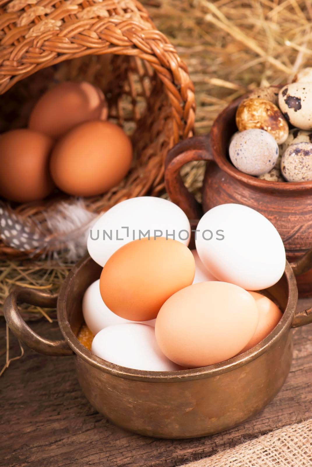 Chicken eggs in basket on wooden background by aprilphoto