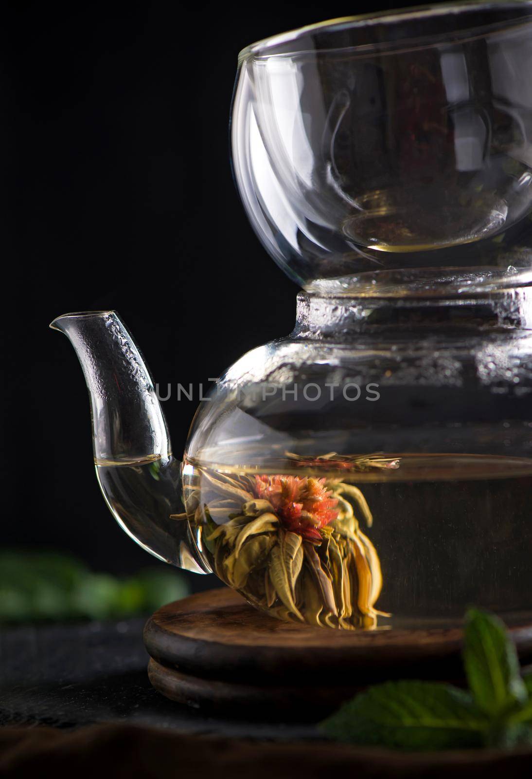 Tea concept, teapot with tea surrounded on wood background, tea ceremony, green tea in a transparent cup by aprilphoto