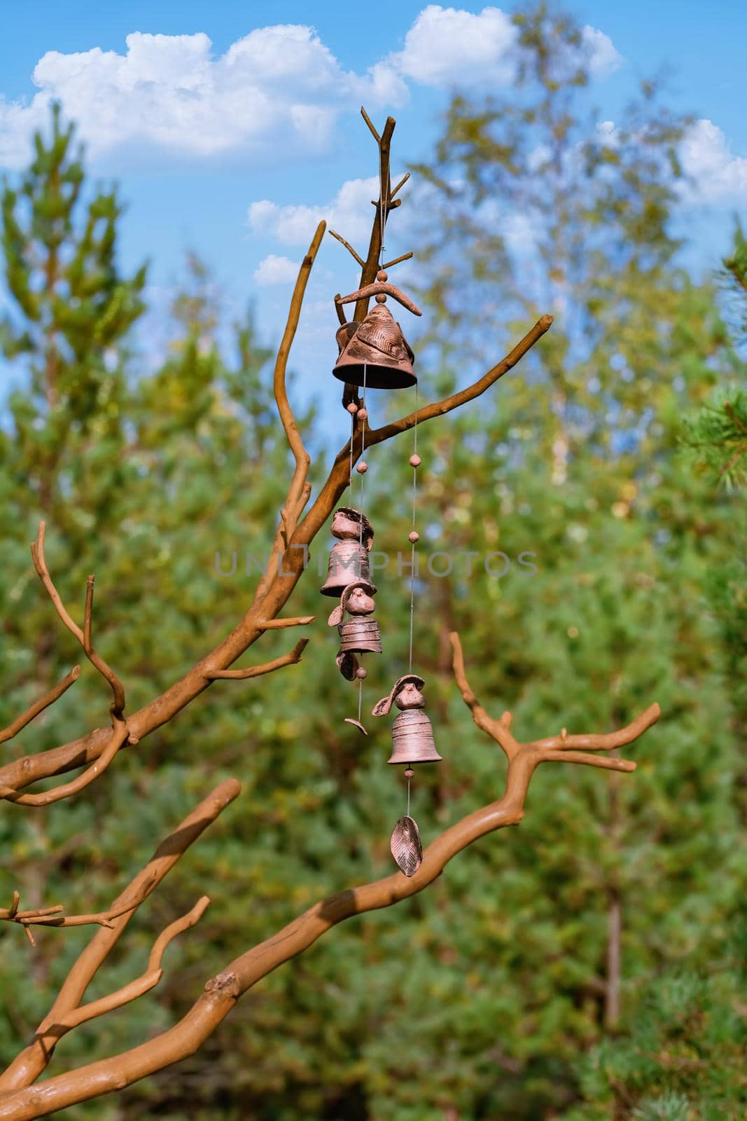 Сlay bells hanging on the dry tree