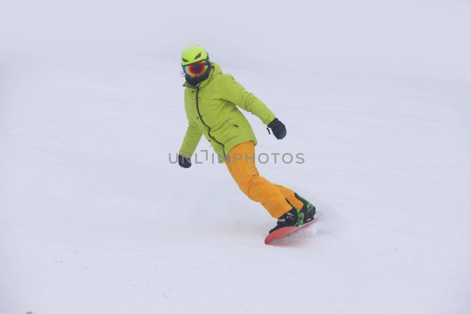 Woman snowboarder on the slopes frosty winter day. Girl on snowboard in the snow