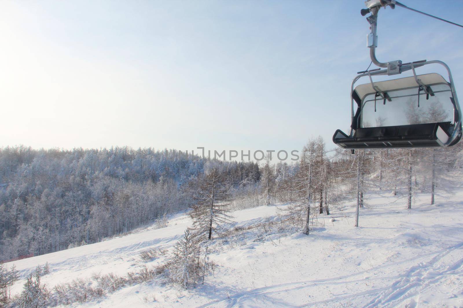 Winter snow mountain landscape with pine trees at ski resort Abzakovo region, Russia, sunny day