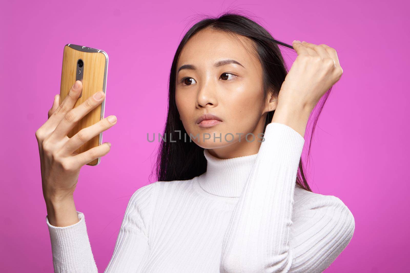 pretty woman asian appearance phone in hands communication technology cropped view. High quality photo