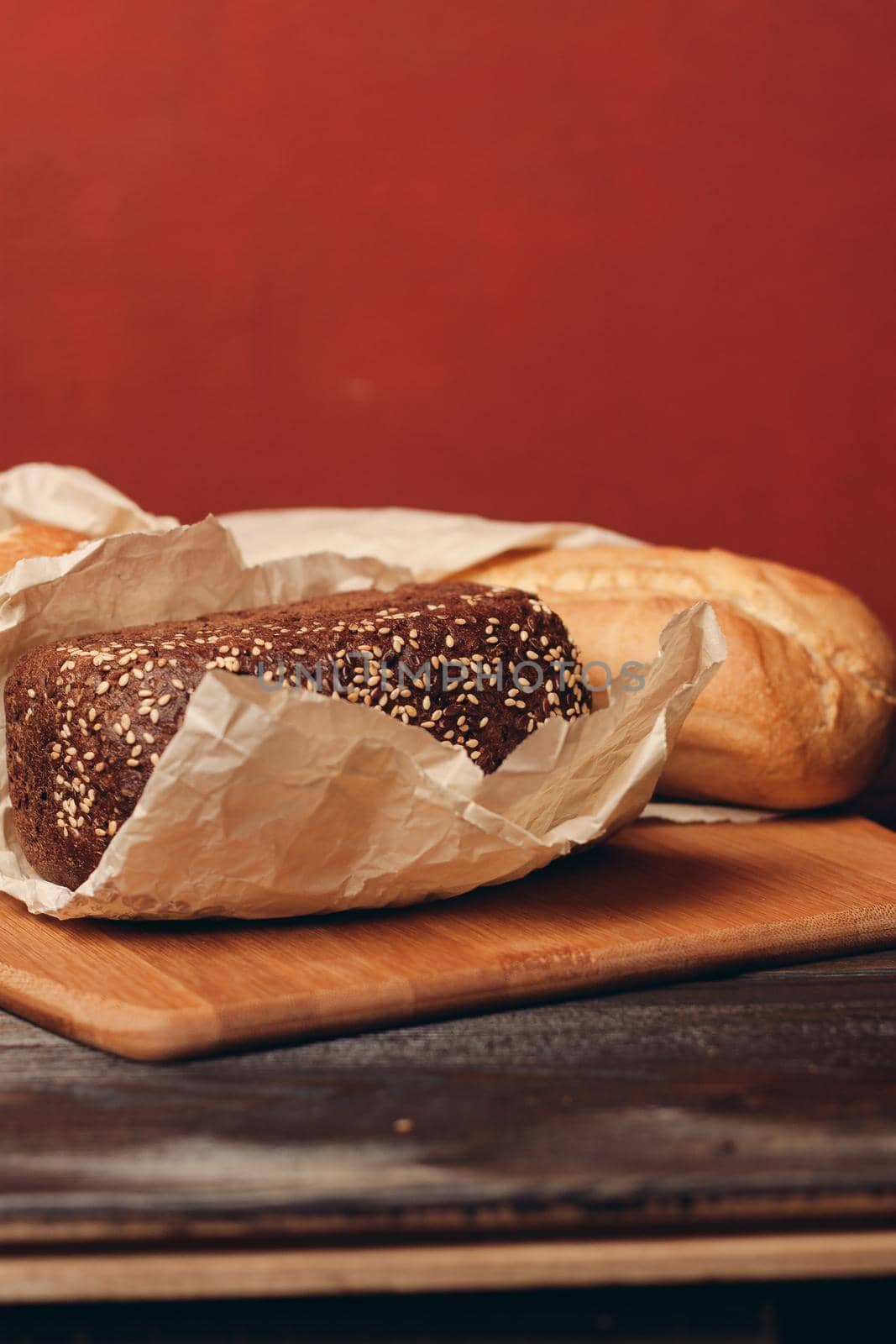 loaf of bread on a board baking flour product and red background. High quality photo