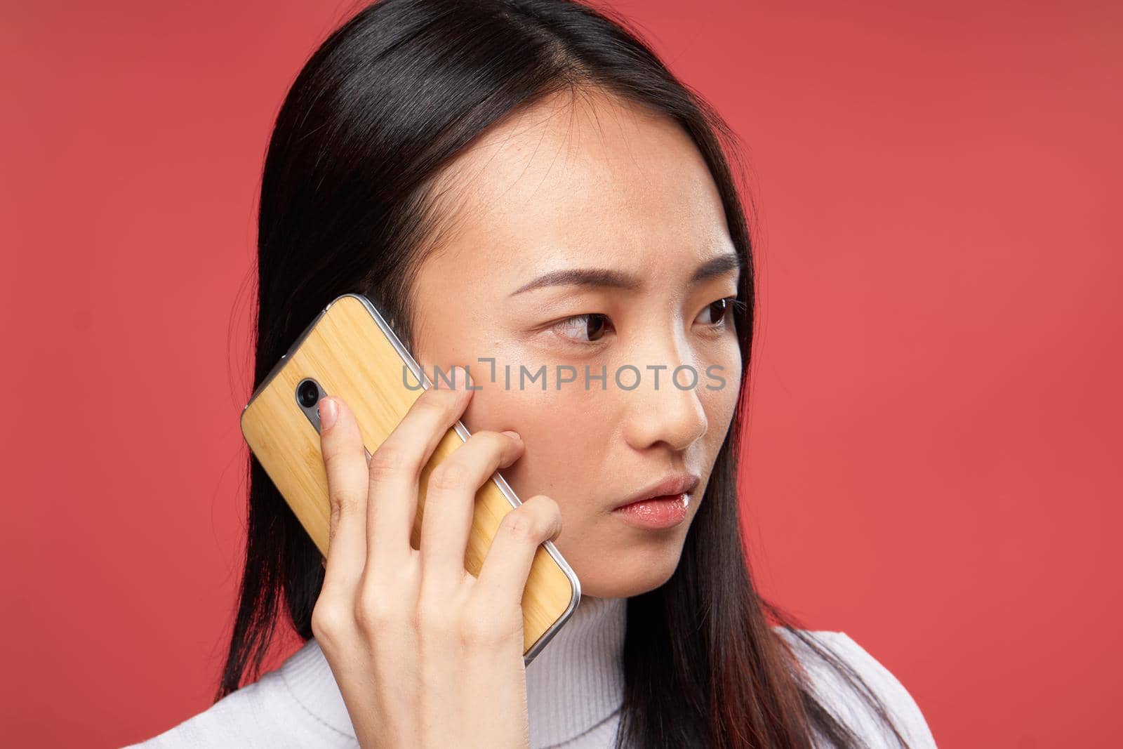 woman asian appearance talking on the phone lifestyle technology red background by SHOTPRIME