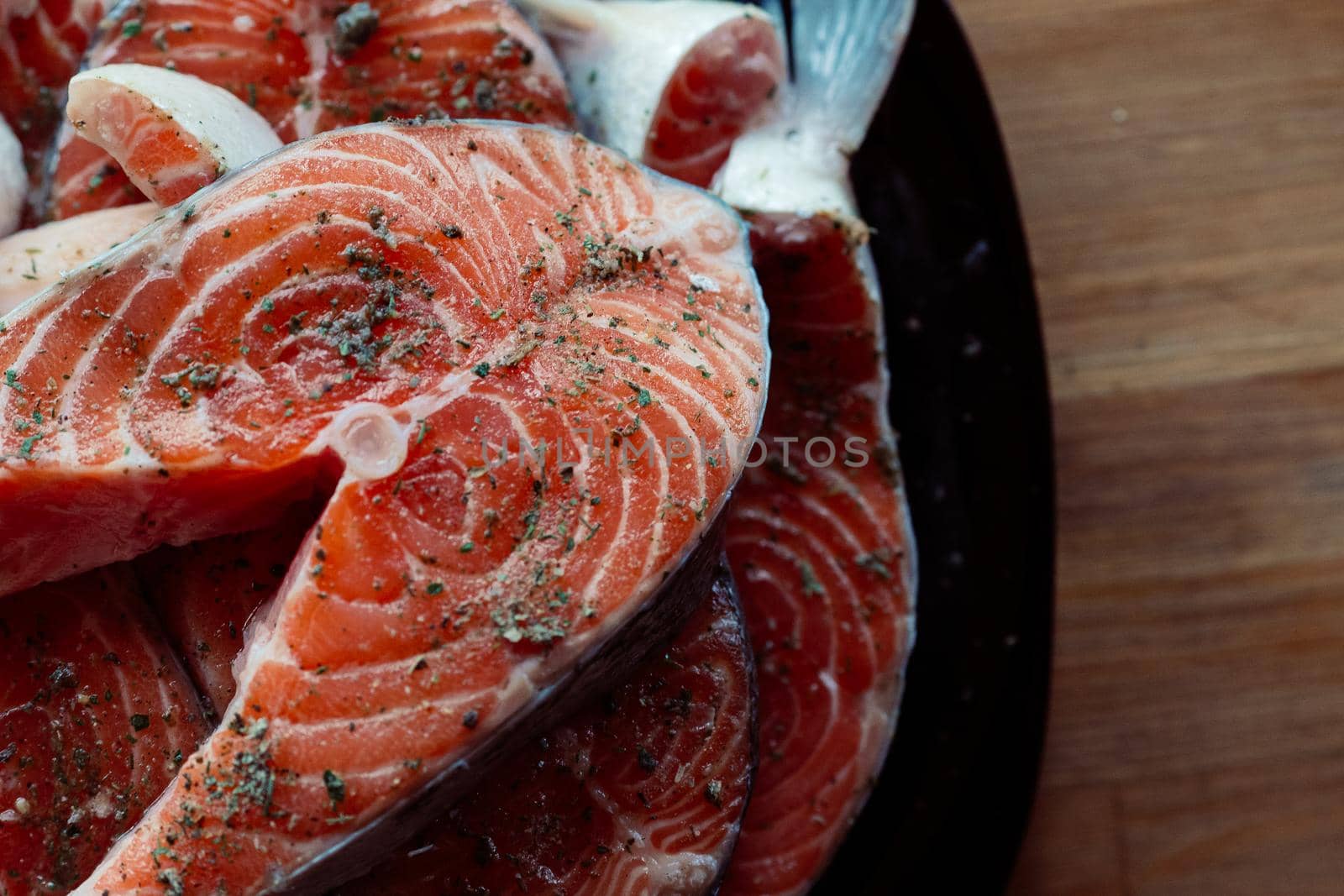 red fish sliced on a plate cooking seafood wooden background. High quality photo